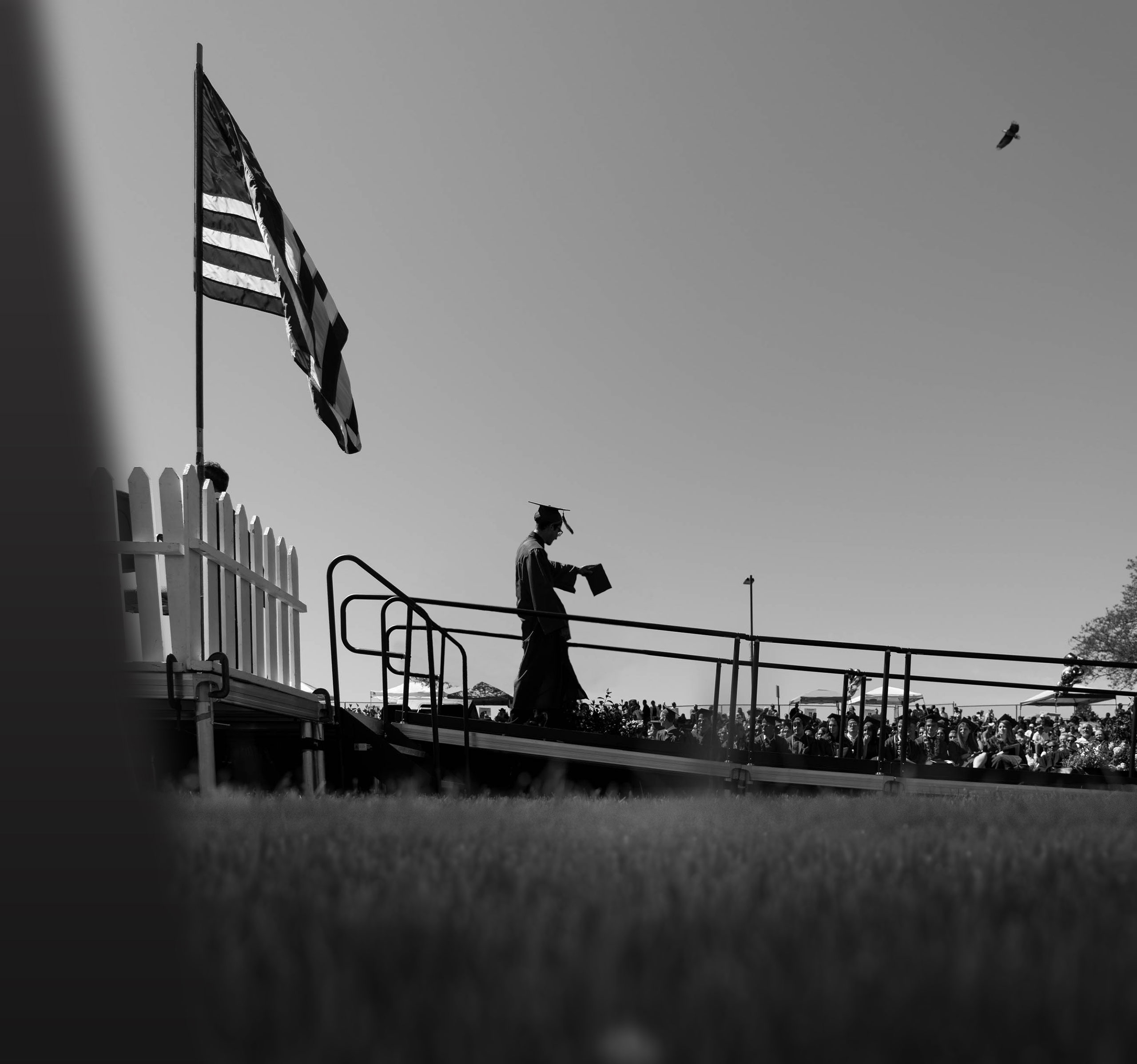 graduate walking with diploma